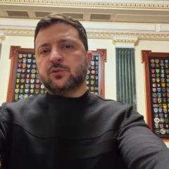 Zelensky in protective gear on foreground