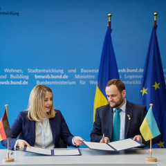 Coat of arms of Ukraine and Germany during signing agreement