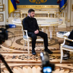 Zelensky speaks against the background of a map