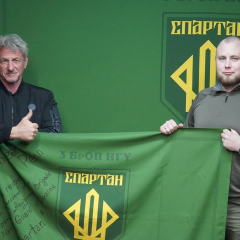 Sean Penn with flag and badge