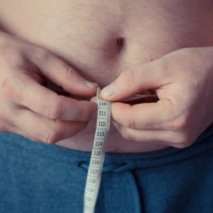 Two opposite weight loss bottles on scales