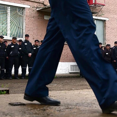 Prisoner with a dart in hand in combat uniform
