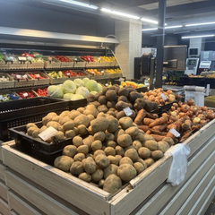 Людина збирає помідори в огороді