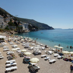 Tourists struggle to find shade on the beach