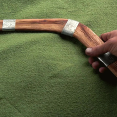 Wooden throwing stick resembling a boomerang