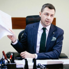 Businessman standing in a forest in Ukraine