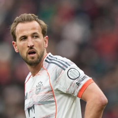 Harry Kane in embroidered shirt, holding trophy