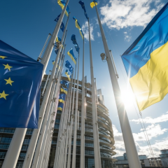 Flag of Ukraine and European Parliament building
