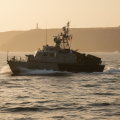 Iranian boats attacking tanker in the Strait of Hormuz