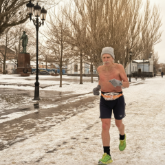 Elderly man running on the street