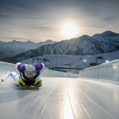Skeleton athlete with helmet featuring portraits of deceased athletes