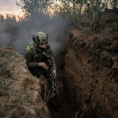 Soldiers in trenches with written book