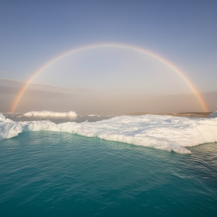 White cheerful rainbow against Antarctic ice