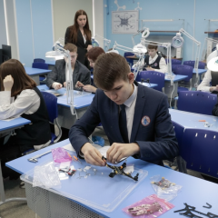 Children learning to control drones in 'Warrior Centers'