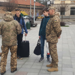 Ukrainian soldier in uniform with robot