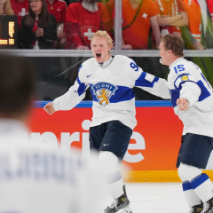 Finland's players celebrating victory in hockey