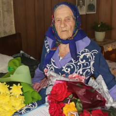Elderly Ukrainian woman with slogan 'Life is beautiful!'
