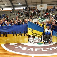 Ukrainian athletes against the backdrop of the Deaflympics 2025 logo