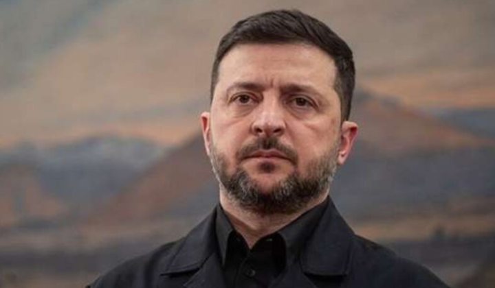 Zelensky speaking in front of Ukrainian flag