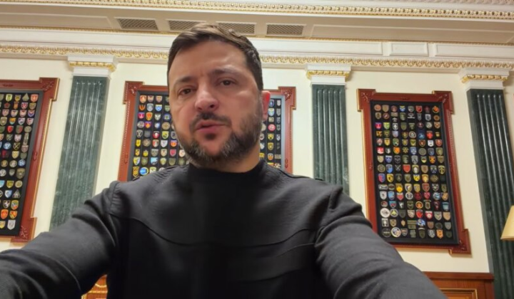 Zelensky in protective gear on foreground