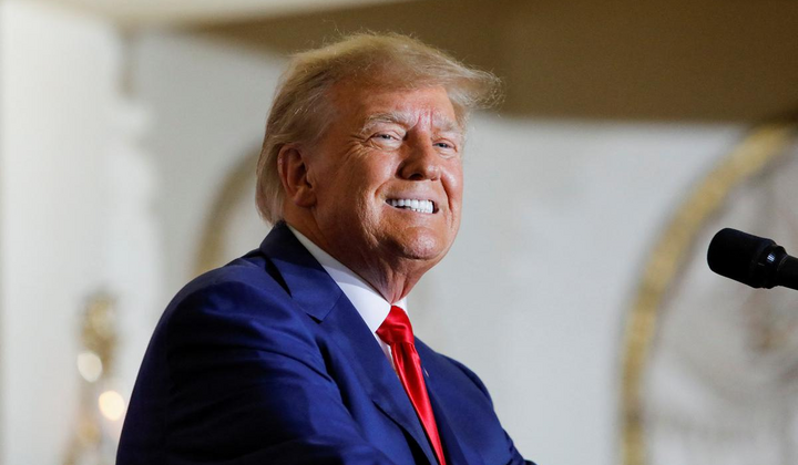Трамп выступает перед большим флагом США