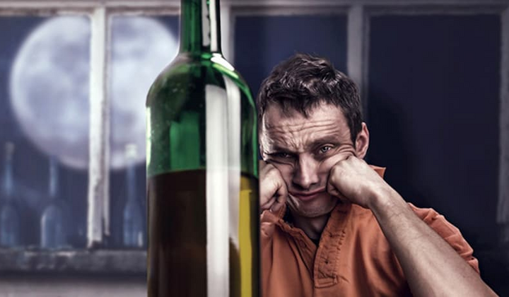 Столовый набор спиртного рядом с потухшей свечой