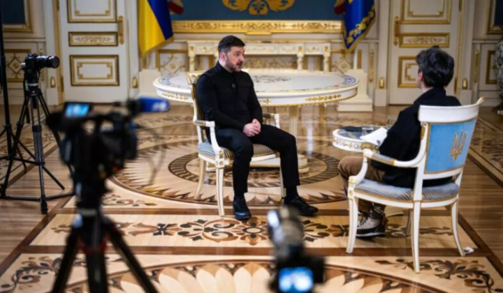 Zelensky speaks against the background of a map