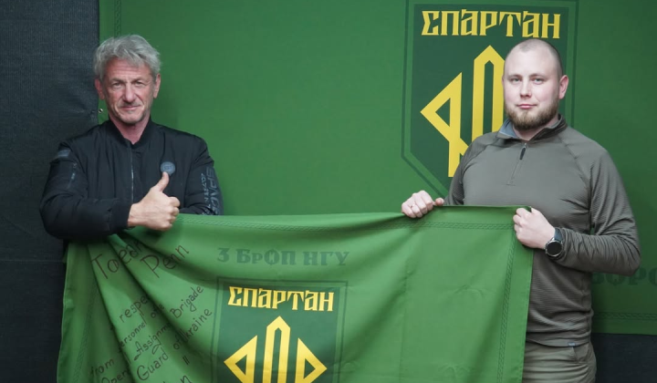 Sean Penn with flag and badge