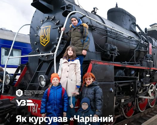 Children ride on a train under shelling