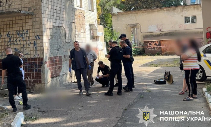 A woman throws her newborn baby out of the window