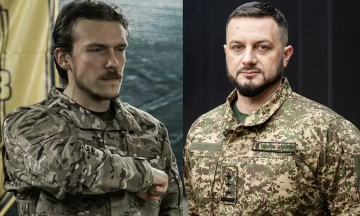 Люди в військовій формі стоять поруч з прапорами