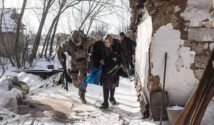 Rescuers evacuate people under shelling