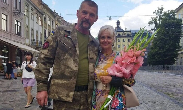 A white woman looks out the window