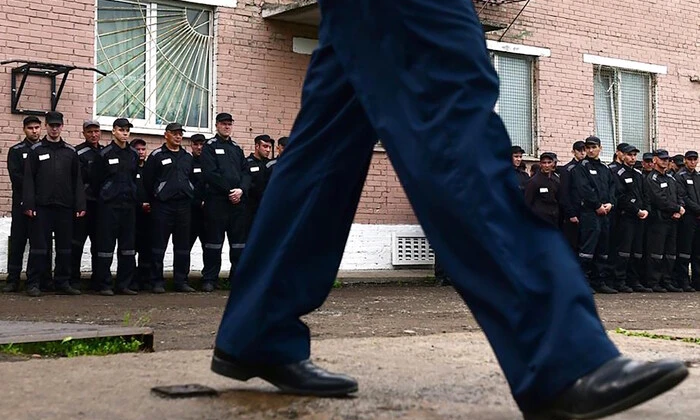 Prisoner with a dart in hand in combat uniform