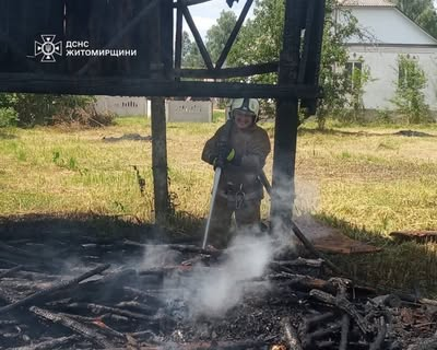 Жінка гасить горять господарську споруду