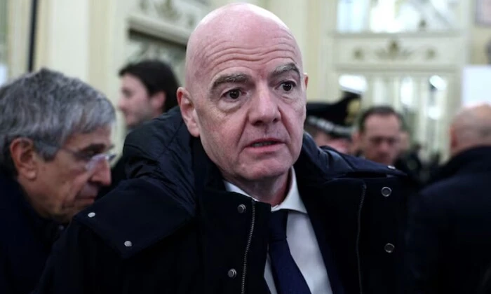 FIFA President Gianni Infantino on a football field background