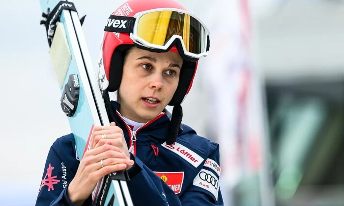 Lisa Eder with Austrian flag in the background
