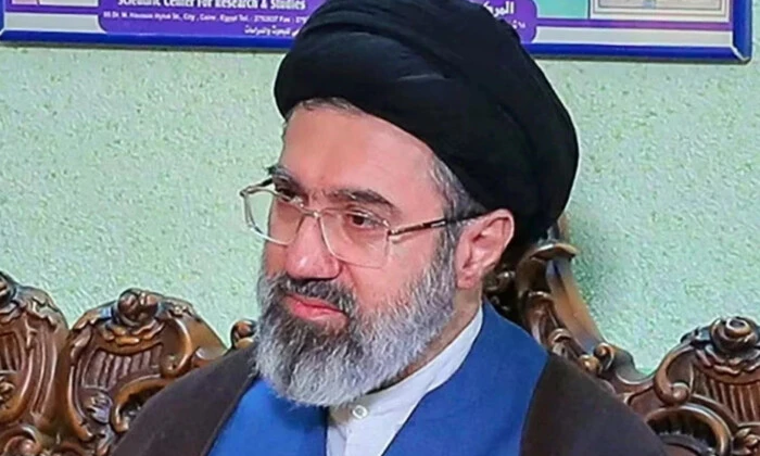 New leader of Iran with raised finger