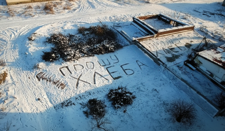 Elderly woman writing on snow