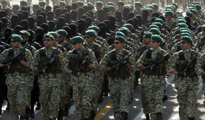Iranian national flag with American military equipment in the background