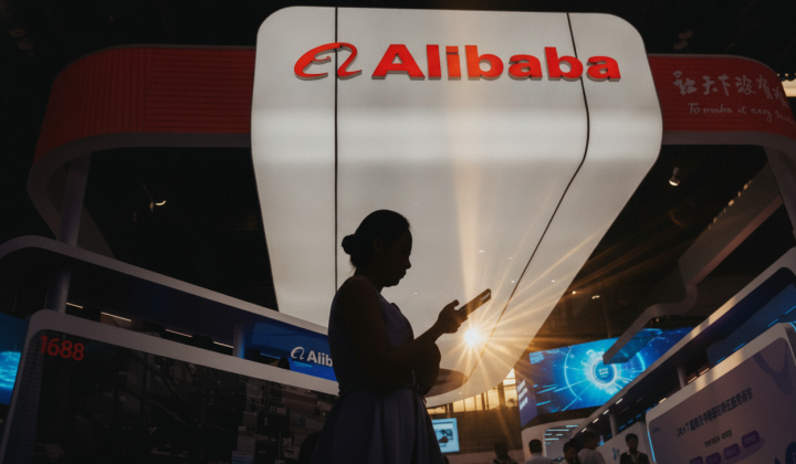 Alibaba company logo on the background of the American flag