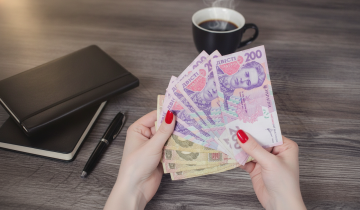 Money in banknotes on Ukrainian flag