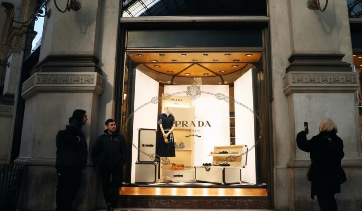 Logos of Prada and Versace on the background